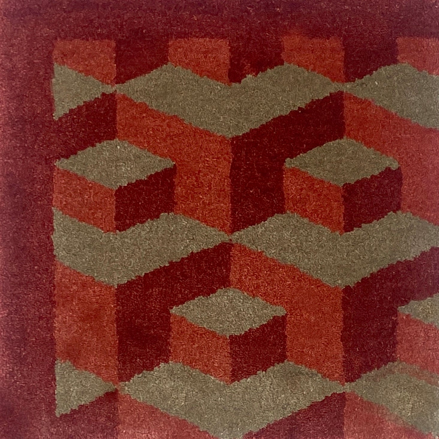 Geometric patterned rug with red and brown colors