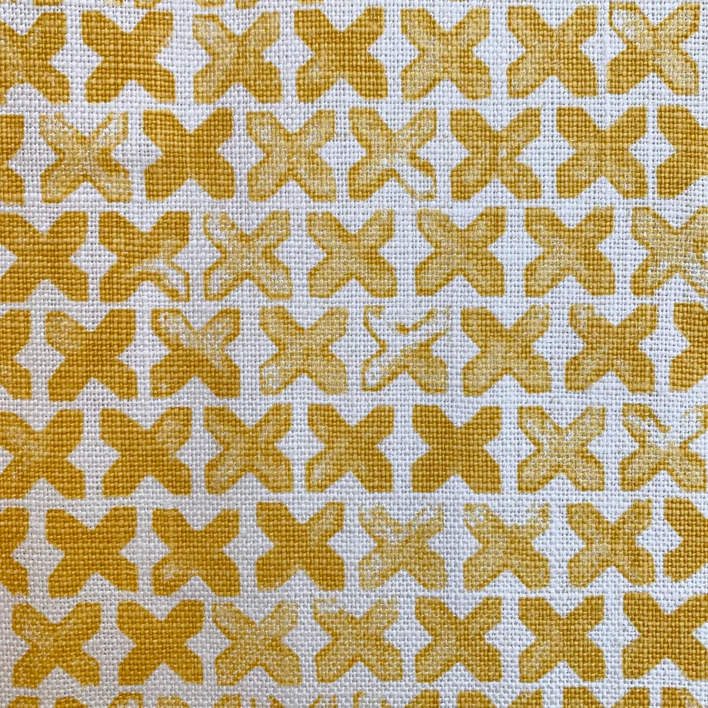 Pattern of yellow cross marks on a white background