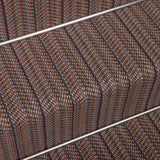 Close-up of a woven stair carpet runner with a textured stripe pattern in pink, brown, beige, and blue.