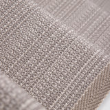 Close-up of flatweave stair runner in a light taupe-beige color, showing the detailed weave and a folded edge.