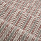Detail of a stair runner in a complex woven stripe design of wool in shades of pink and grey.
