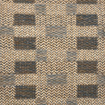 Handwoven rug detail in a checkered design in tan, grey and slate