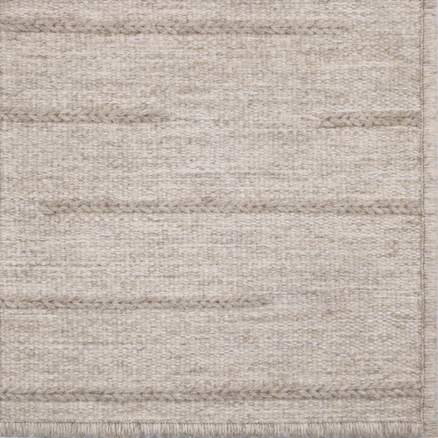 Textured ecru rug with a subtle pattern