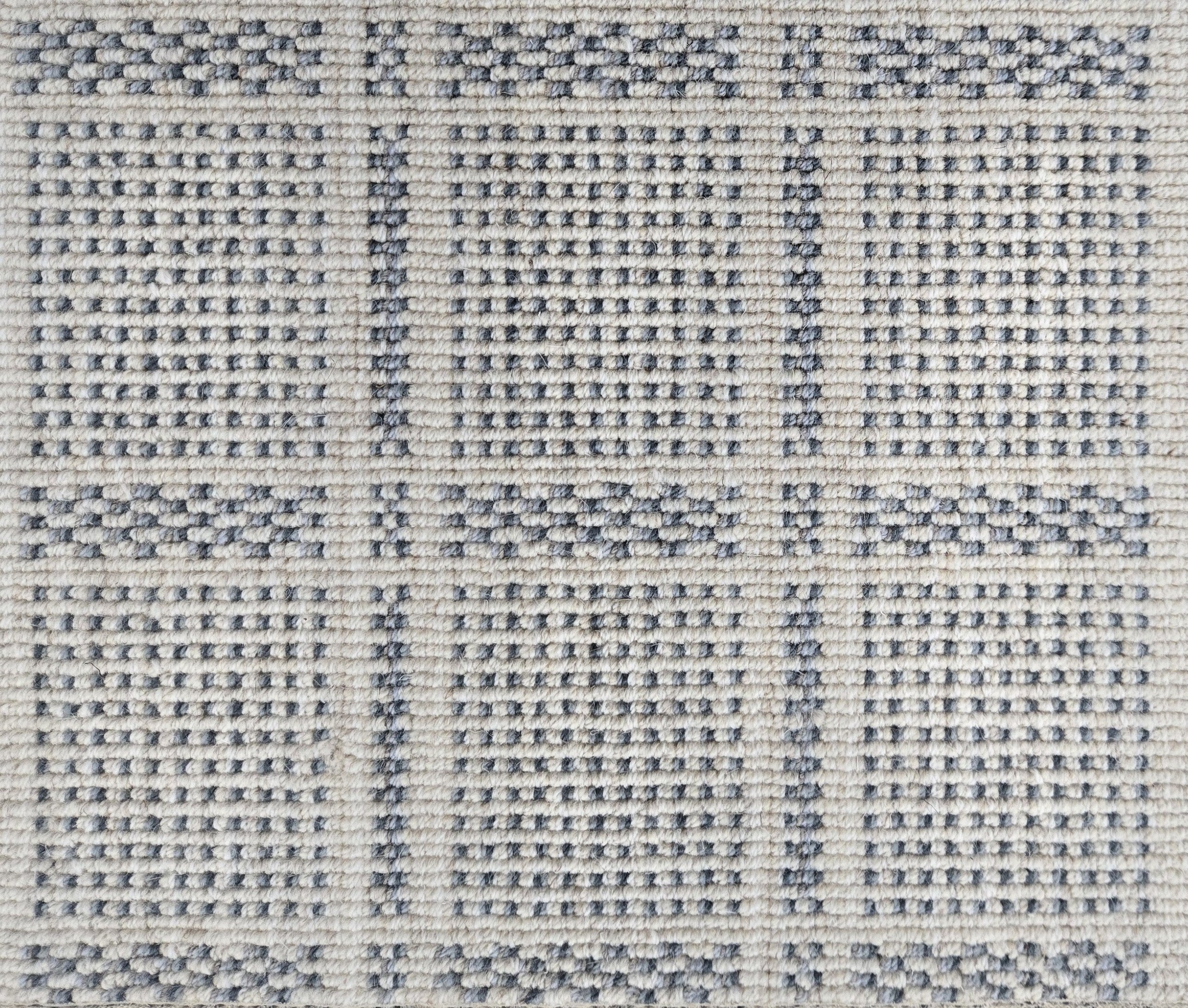 Broadloom carpet in check pattern in shades of blue with cream. 