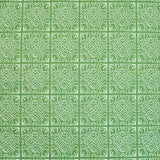 Detail of fabric in a damask lattice print in white on a green field.