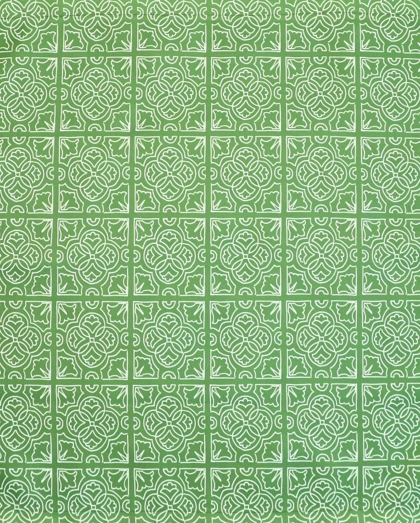 Detail of fabric in a damask lattice print in white on a green field.