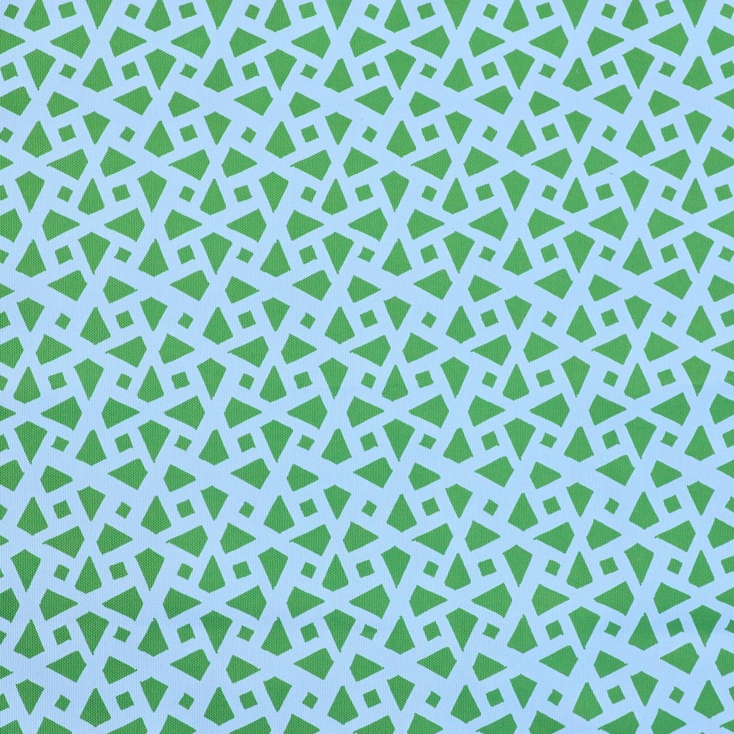 Detail of fabric in a geometric lattice print in green on a light blue field.