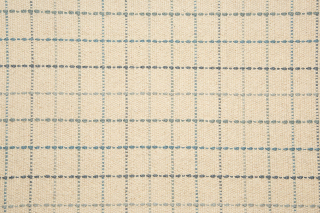 Broadloom carpet with window pane plaid in shades of blue on a cream field. 