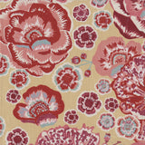 Detail of fabric in a floral print in shades of pink, red and blue on a tan field.