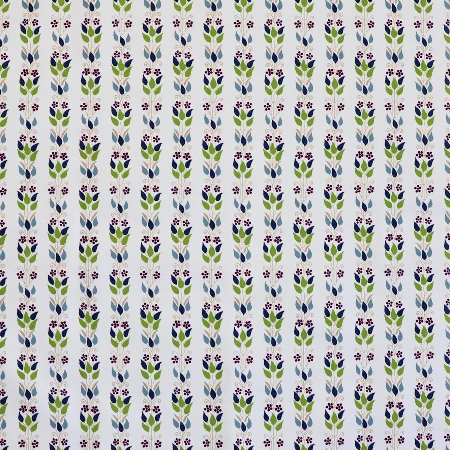 Detail of fabric in a striped botanical print in shades of blue, purple and green on a cream field.