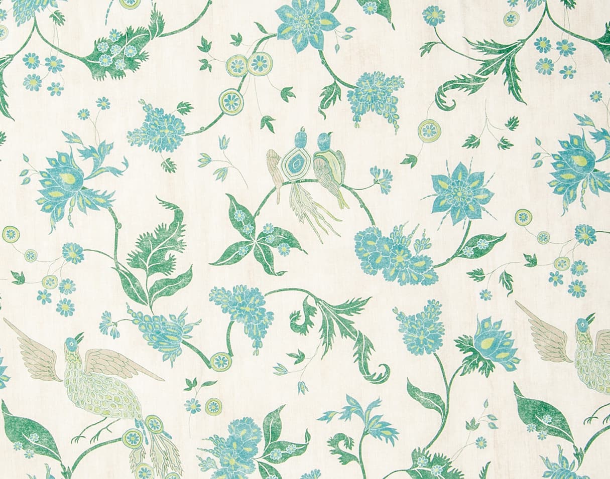 Detail of wallpaper in a bird and botanical print in shades of green, turquoise and yellow on a cream field.