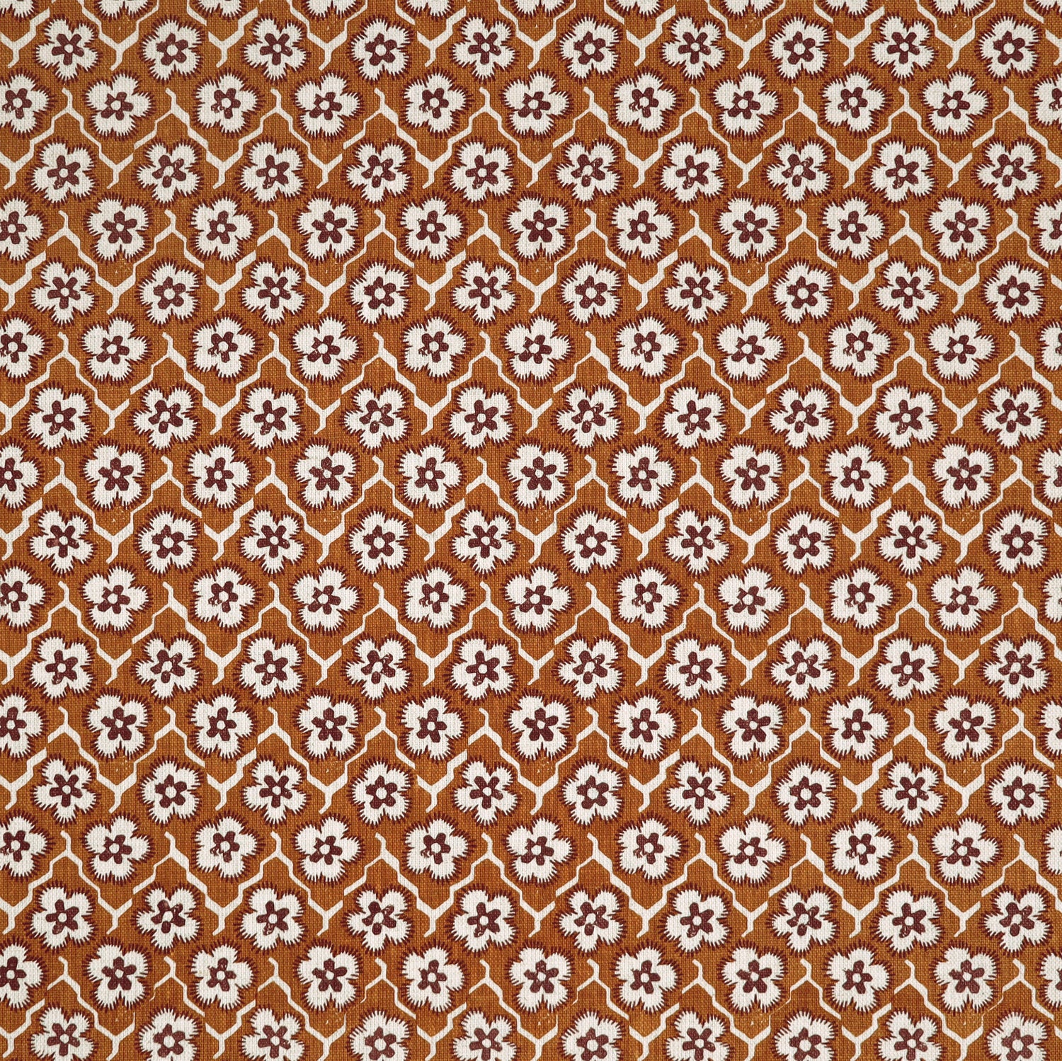 Fabric with small scale floral pattern in white, eggplant and orange.