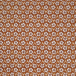 Fabric with small scale floral pattern in white, eggplant and orange.