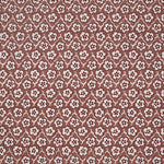 Fabric with small scale floral pattern in white, purple and clay pink.