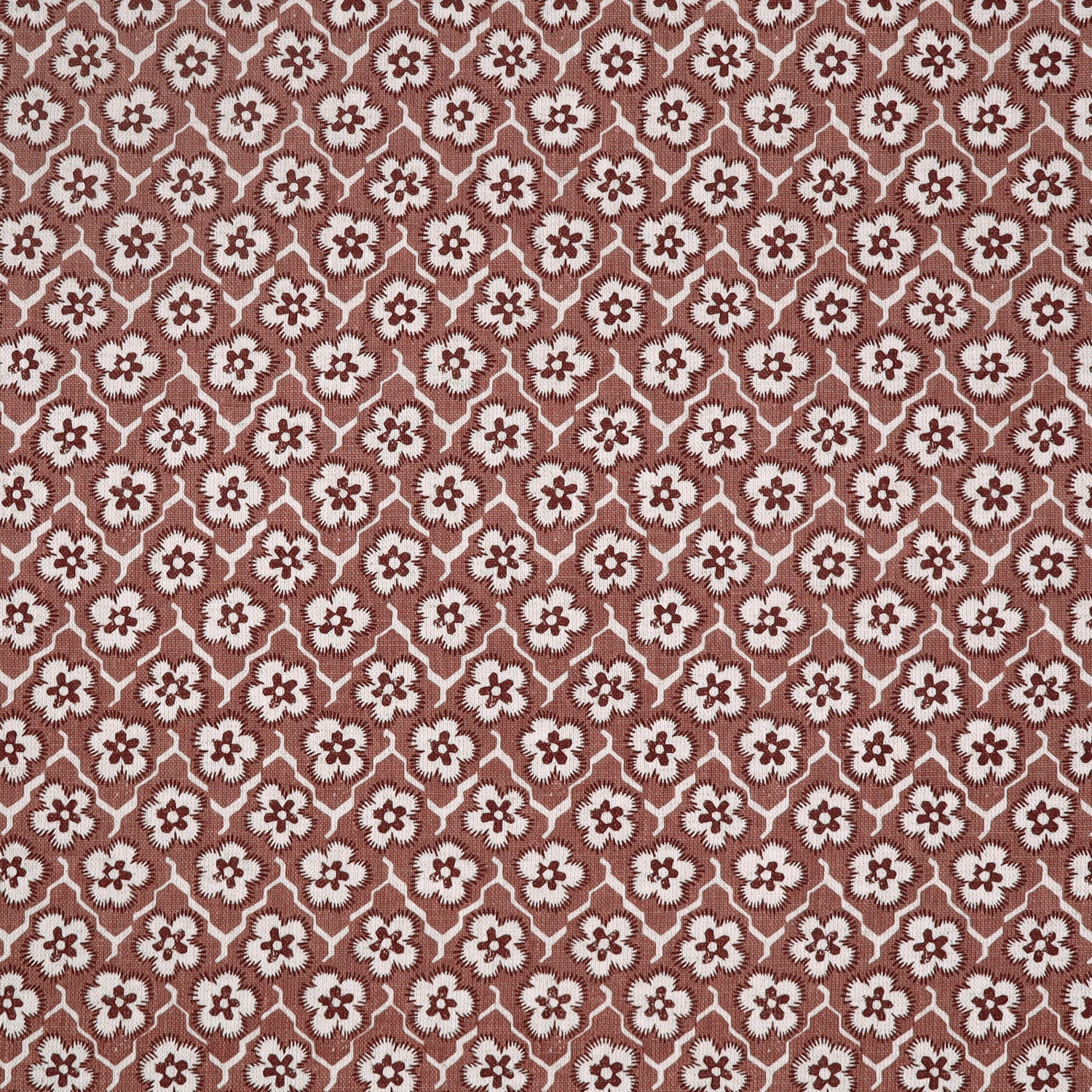 Fabric with small scale floral pattern in white, purple and clay pink.