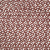 Fabric with small scale floral pattern in white, purple and clay pink.