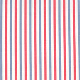 Detail of fabric in a small-scale stripe print in red and blue on a white field.