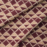 Draped fabric with a geometric pattern of triangles in wine purple and brown.