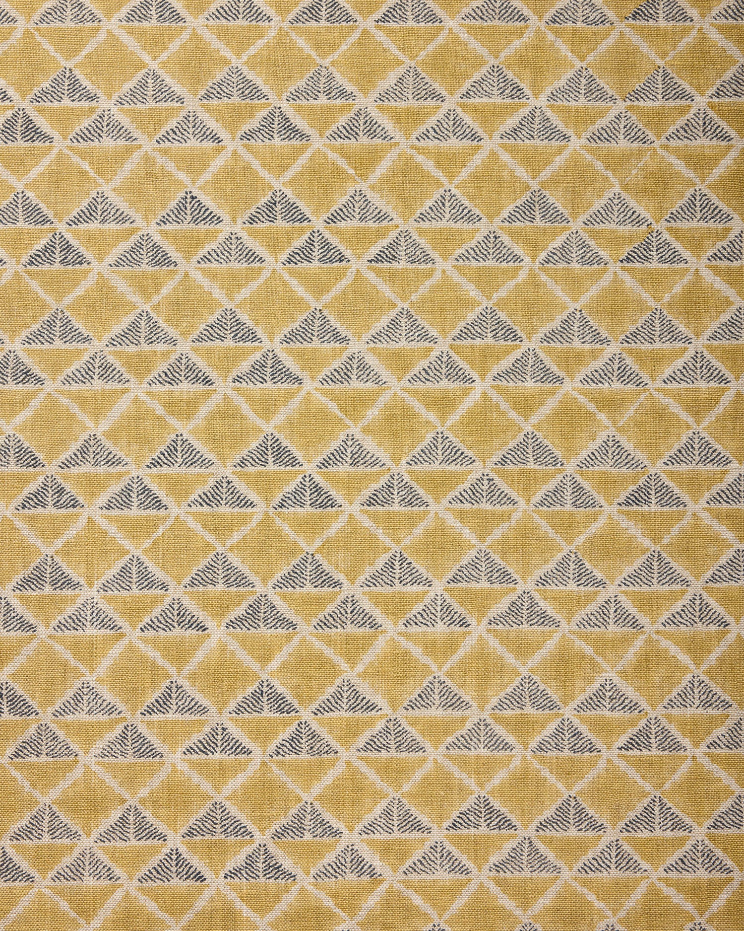Fabric with a tan and navy blue geometric pattern.