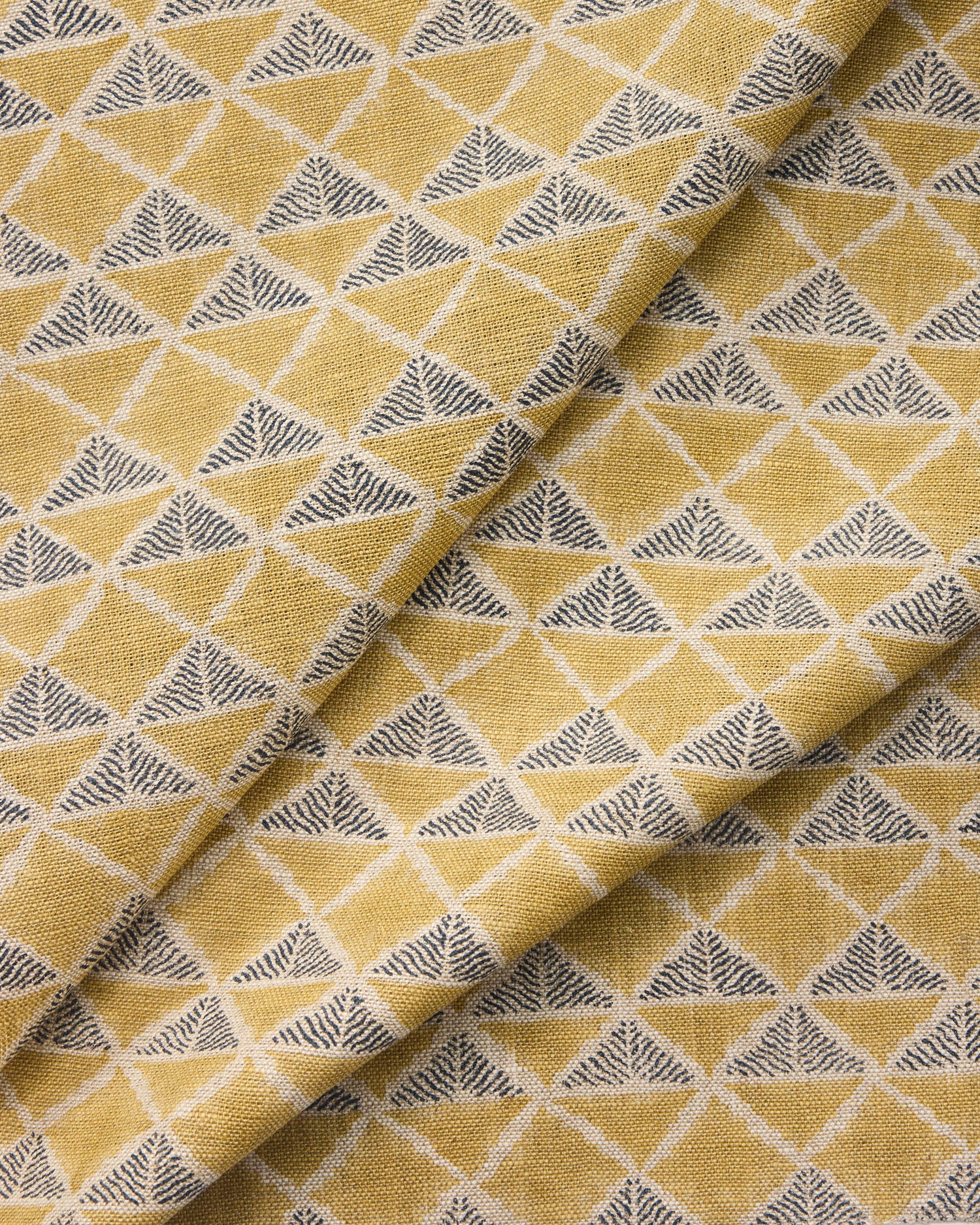 Draped fabric with a tan and navy blue geometric pattern