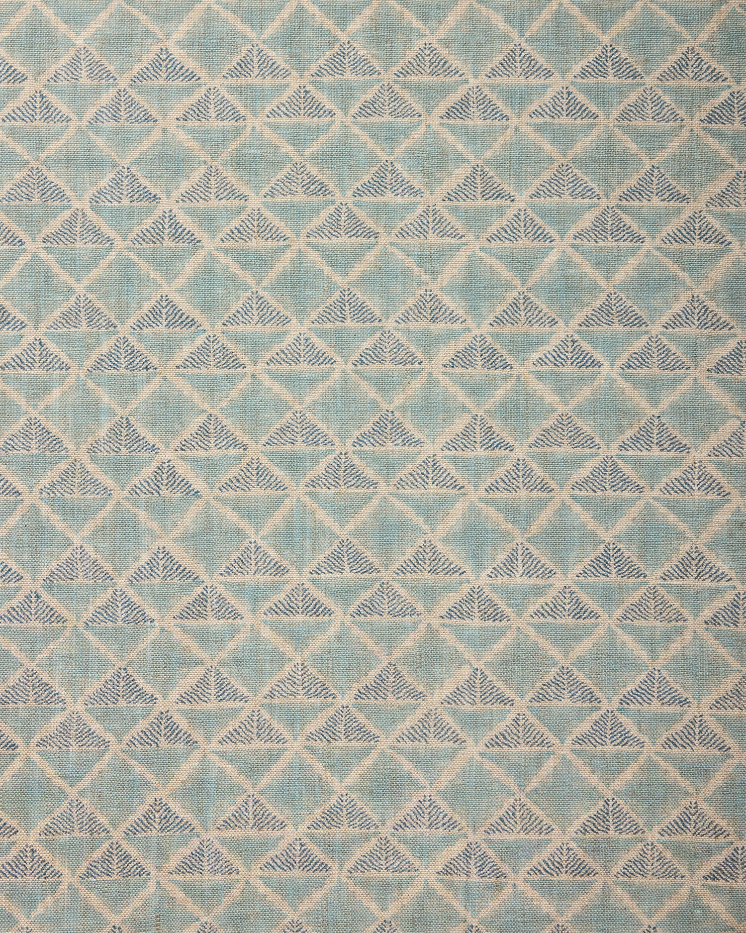 Textile pattern with geometric design in shades of blue.