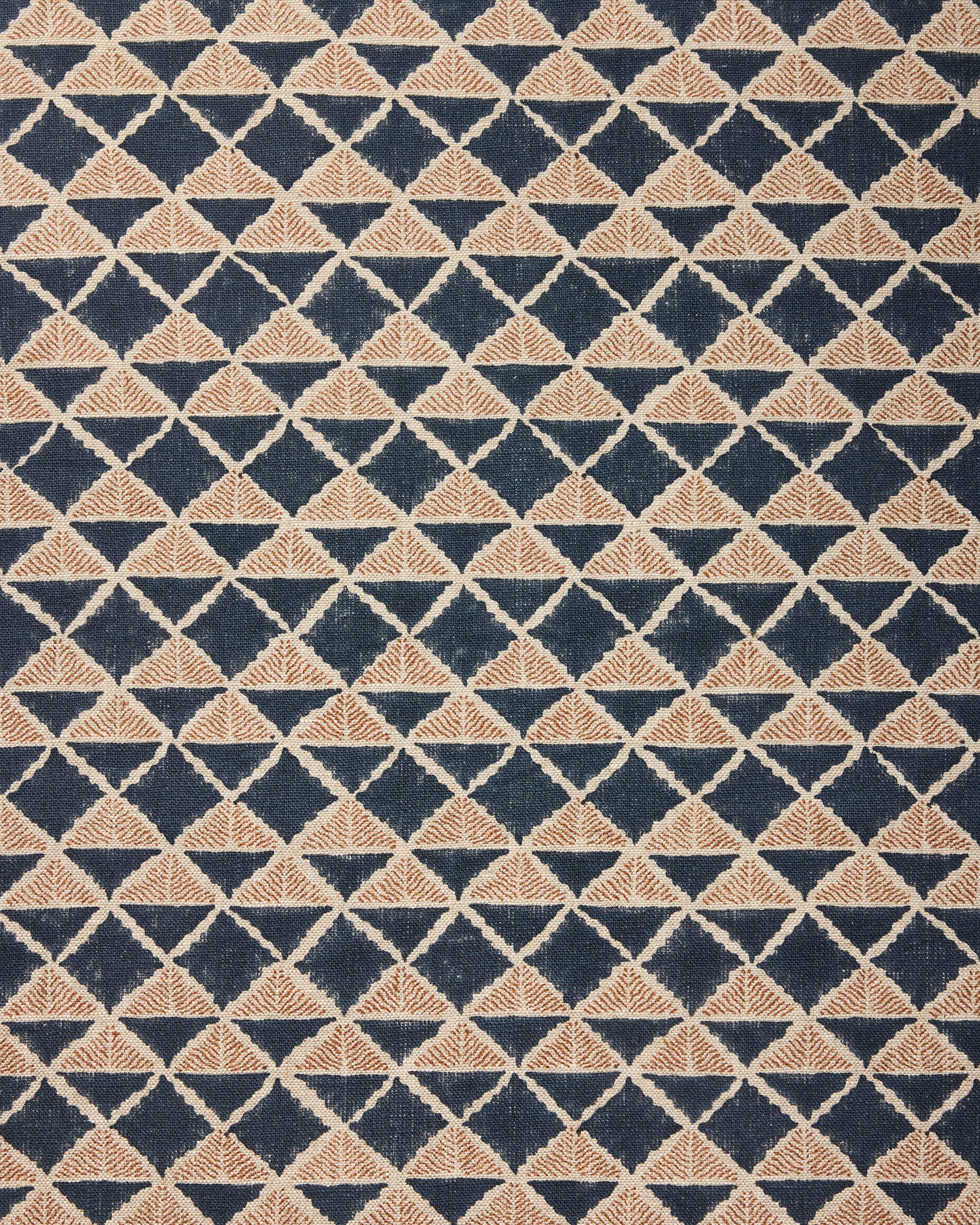 Fabric with a geometric pattern of triangles in wine navy blue and brown.