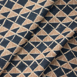 Draped fabric with a geometric pattern of triangles in navy blue and brown.