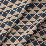 Draped fabric with a geometric pattern of triangles in navy blue and brown.