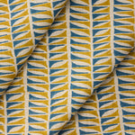 Draped close-up of fabric with a geometric leaf pattern in blue and ochre.
