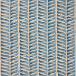 Close-up of fabric with a geometric leaf pattern in blue.