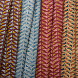 Four fabric swatches with geometric patterns in different colors.