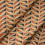 Draped fabric with a geometric triangle pattern in red, blue, and beige.