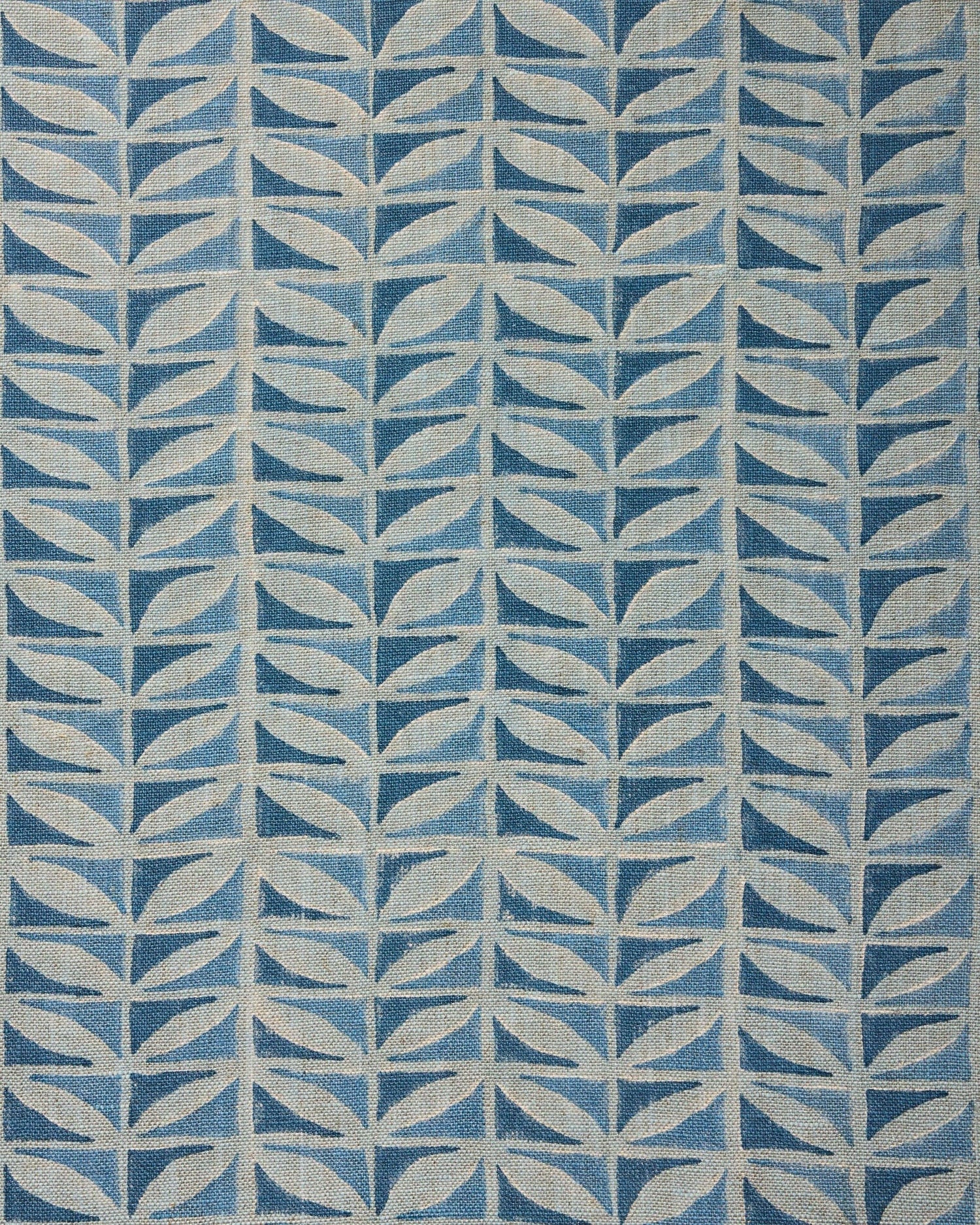 Close-up of fabric with a leaf pattern in shades of blue.