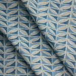 Draped close-up of fabric with a leaf pattern in shades of blue.