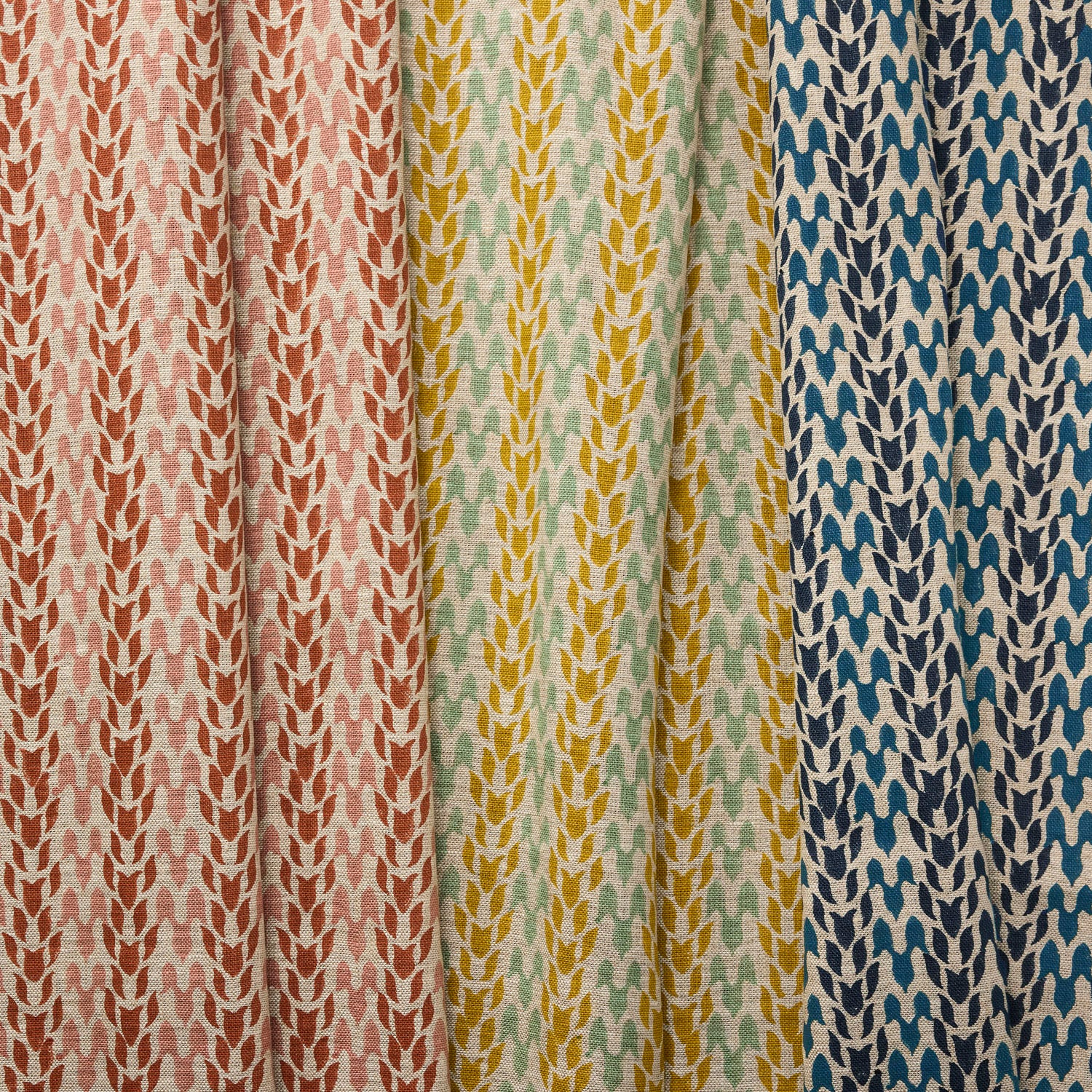 Three fabric swatches abstract leaf patterns in various colors.