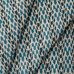 Draped fabric with abstract leaf pattern in shades of blue. 