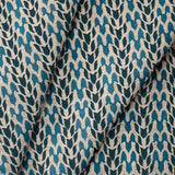 Draped fabric with abstract leaf pattern in shades of blue. 