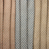 Three fabric swatches diamond pattern in red, blue and tan.