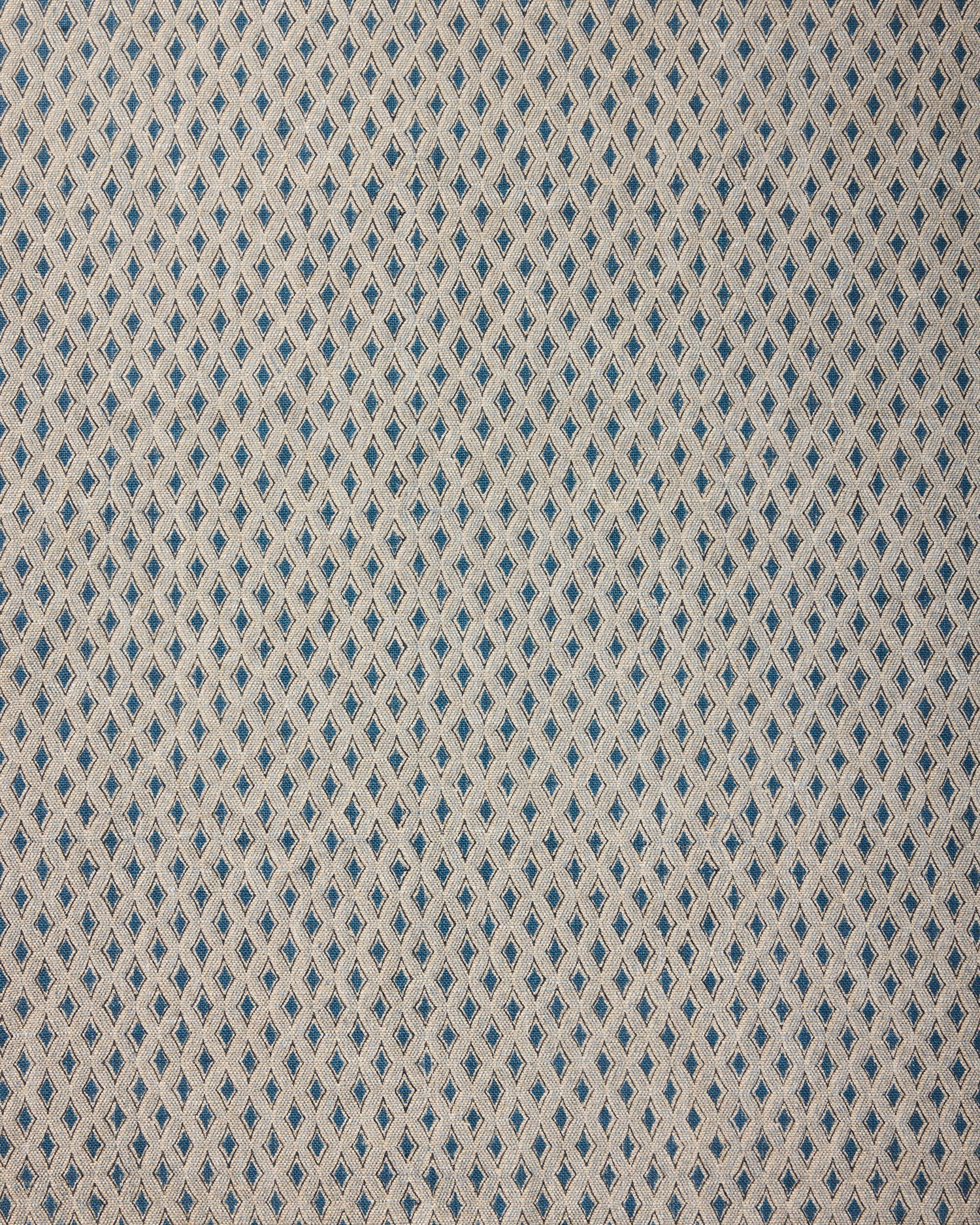 Textile pattern with blue and beige diamonds on a textured background