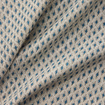Draped close-up of patterned fabric with blue diamond shapes