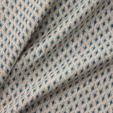 Draped close-up of patterned fabric with blue diamond shapes