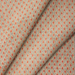 Draped fabric with a diamond pattern in red and beige. 