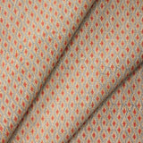 Draped fabric with a diamond pattern in red and beige. 