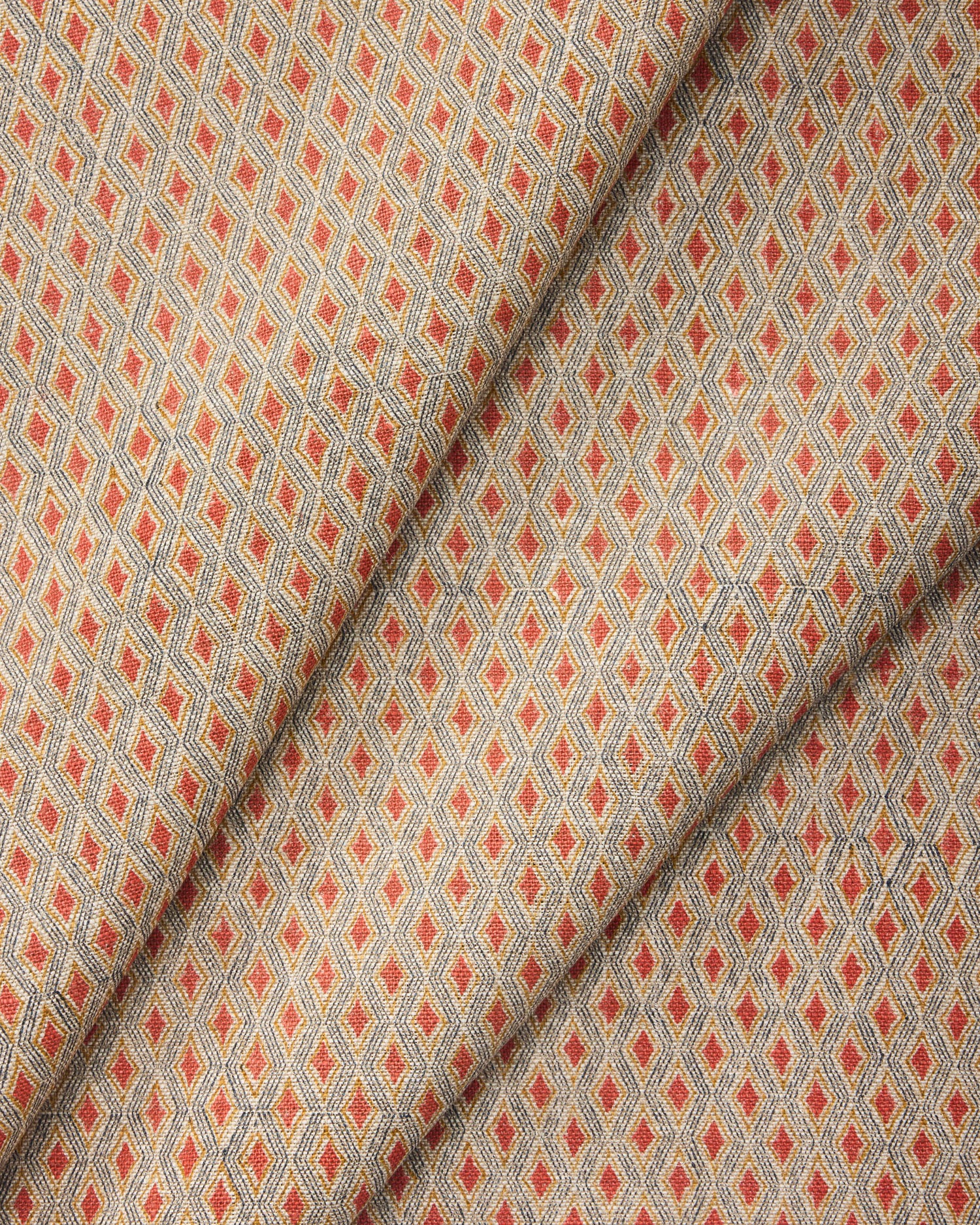 Draped fabric with a diamond pattern in red and beige. 