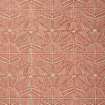 Fabric with geometric sun pattern in clay pink and rust red.