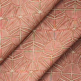 Draped fabric with geometric sun pattern  in clay pink and rust red.