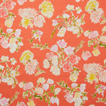 Linen swatch with a pattern of large-scale line-drawn flowers in gray ink with red, pink and yellow watercolors, on a red background.