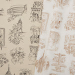 Two overlapping linen swatches in different colorways of the same hand-drawn New York City landmarks pattern.