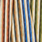 A group of draped woven fabrics, each in a different colorway of a curvy hand-painted stripe pattern.