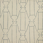 Woven fabric swatch in a repeating curvolinear print in navy on a tan field.